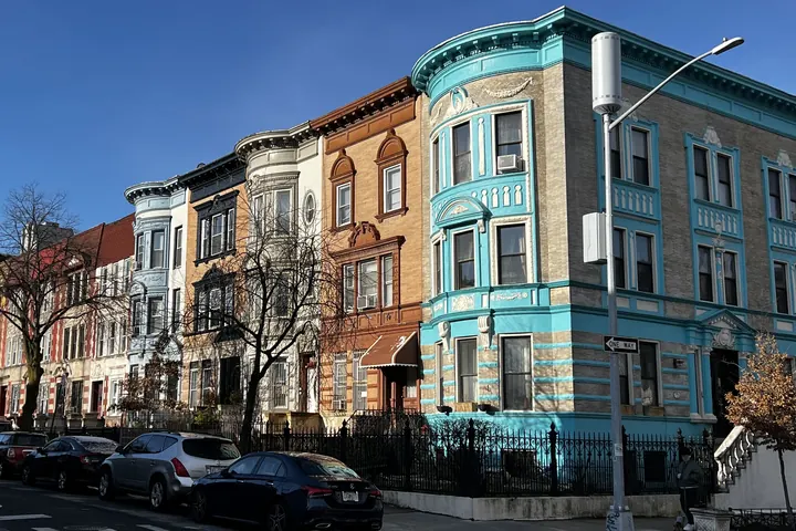 A three-storey corner building at a Brooklyn intersection.