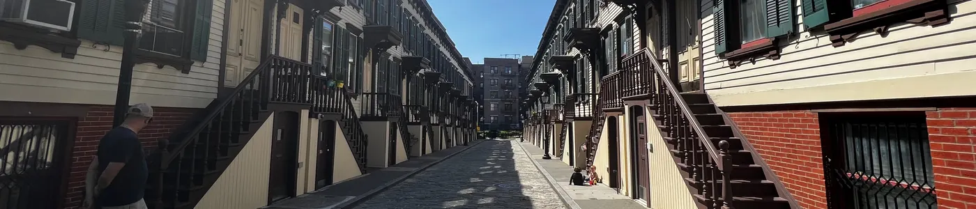 A row of New York row houses along a quiet street.